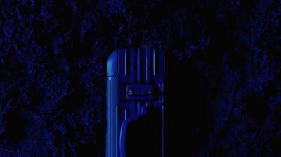 a blue piece of luggage sitting in the dark