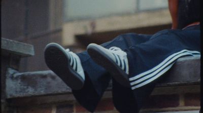 a person sitting on a ledge with their feet up