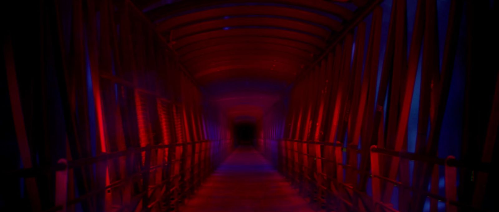 a long hallway with red and blue lights