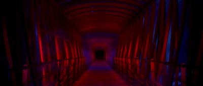 a long hallway with red and blue lights