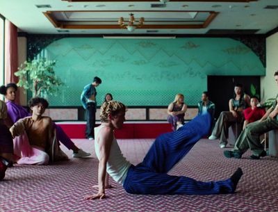 a group of people sitting and standing around in a room