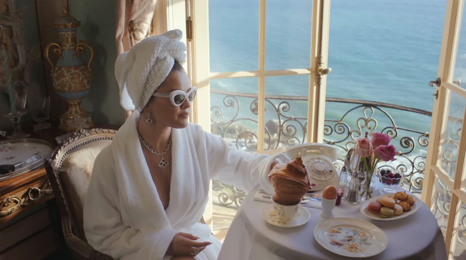 a woman sitting at a table with a plate of food