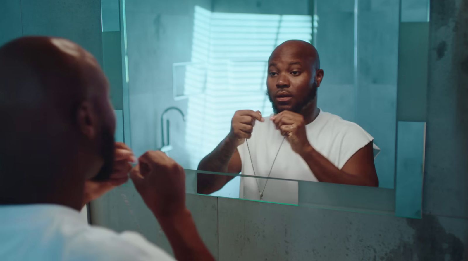 a man brushing his teeth in front of a mirror