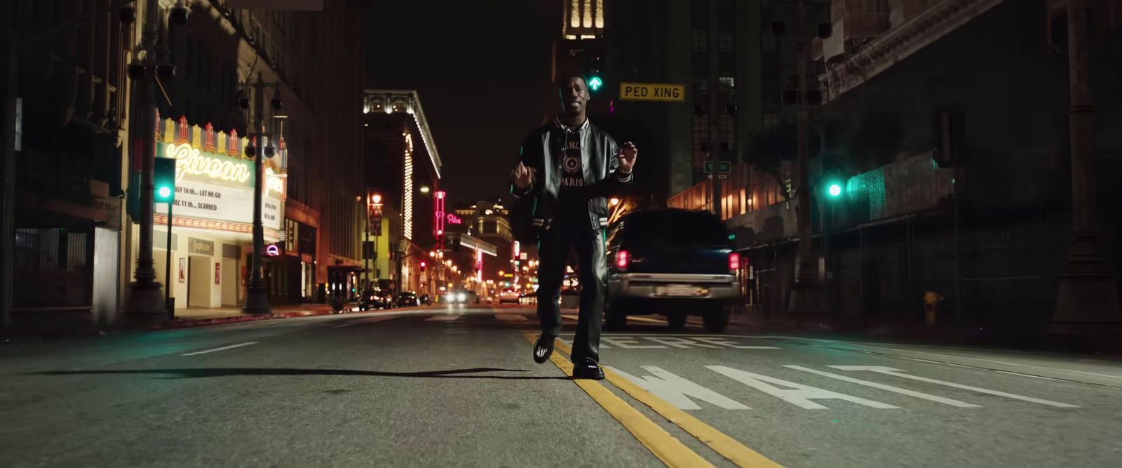 a man riding a motorcycle down a street at night