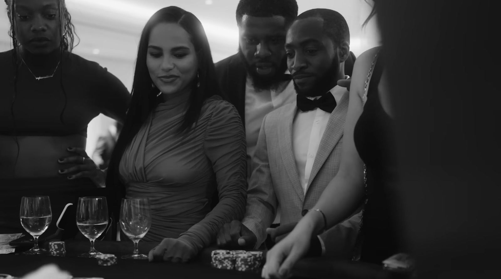 a group of people standing around a table with wine glasses