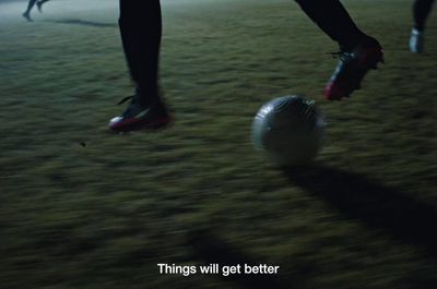 a person kicking a soccer ball on a field