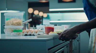 a person preparing food on a counter in a kitchen