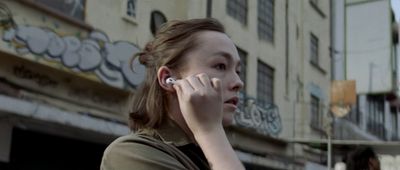 a woman talking on a cell phone in front of a building