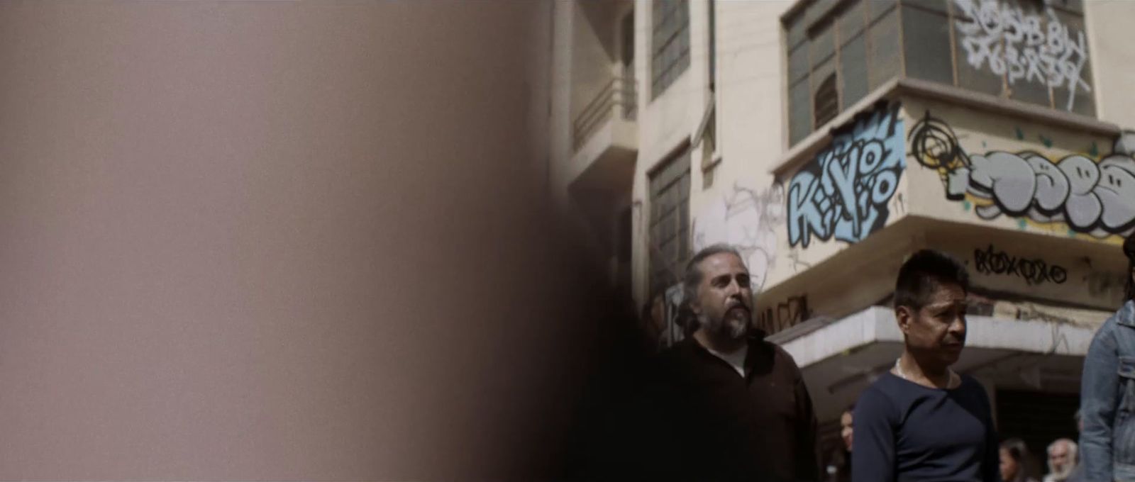 a group of men standing in front of a building