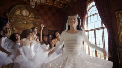 a group of young women dressed in white dancing