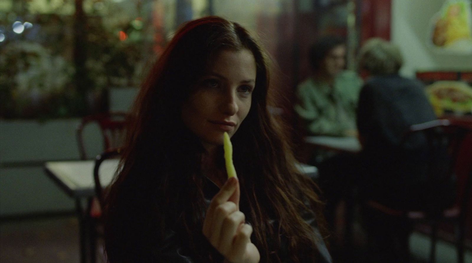 a woman holding a toothbrush in her hand