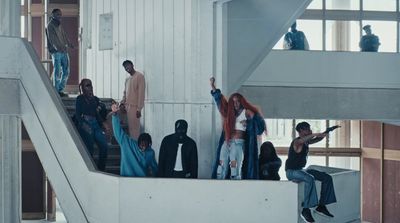 a group of people standing on top of an escalator