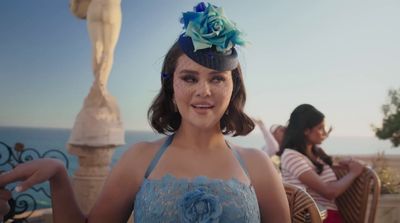 a woman wearing a blue dress and a flower in her hair