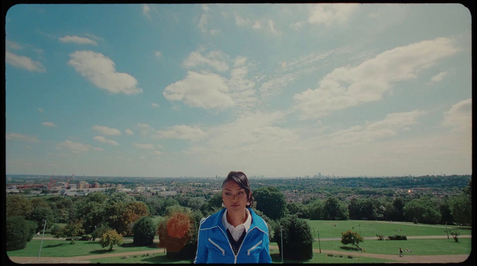 a woman standing on top of a lush green field