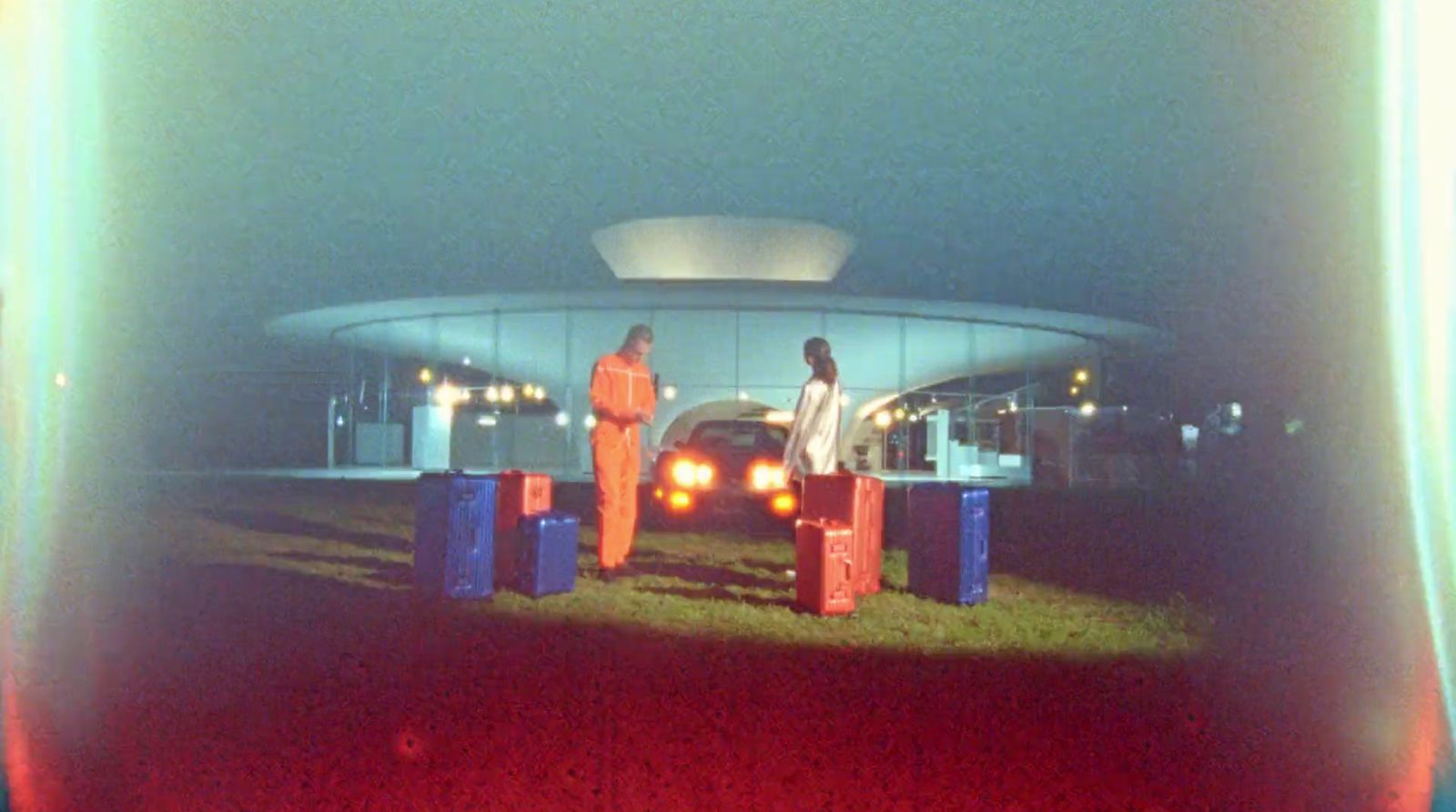 a couple of men standing next to each other in front of a building