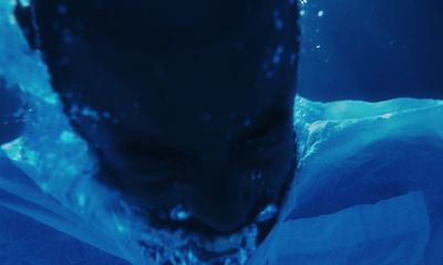 a close up of a person's face under water