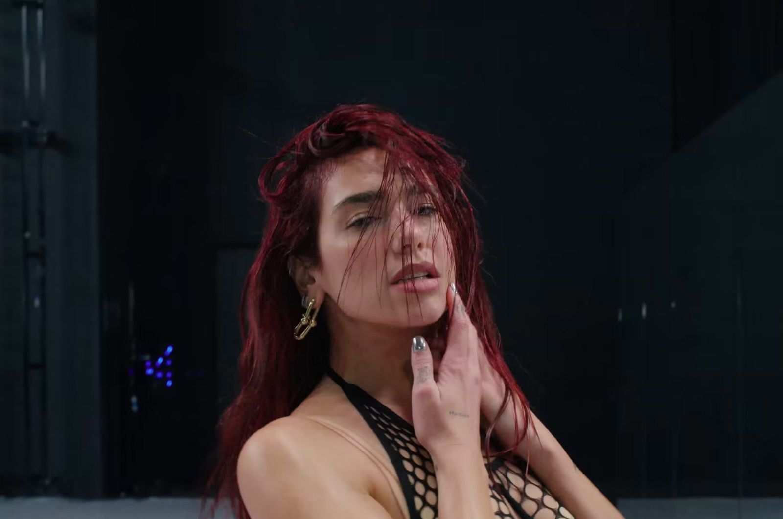 a woman with red hair is posing for a picture