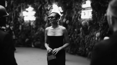 a black and white photo of a woman in a strapless dress