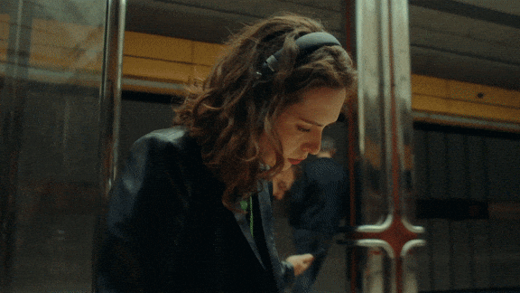 a woman sitting on a train looking at her cell phone