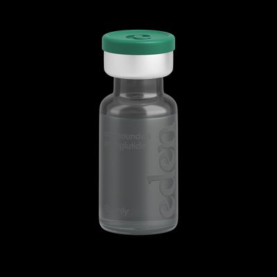 a small bottle with a green lid on a black background