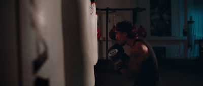 a man standing next to a punching bag