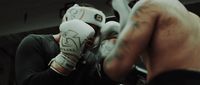 a man in a boxing ring with his hands on his face