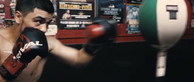 a man wearing boxing gloves in a boxing ring