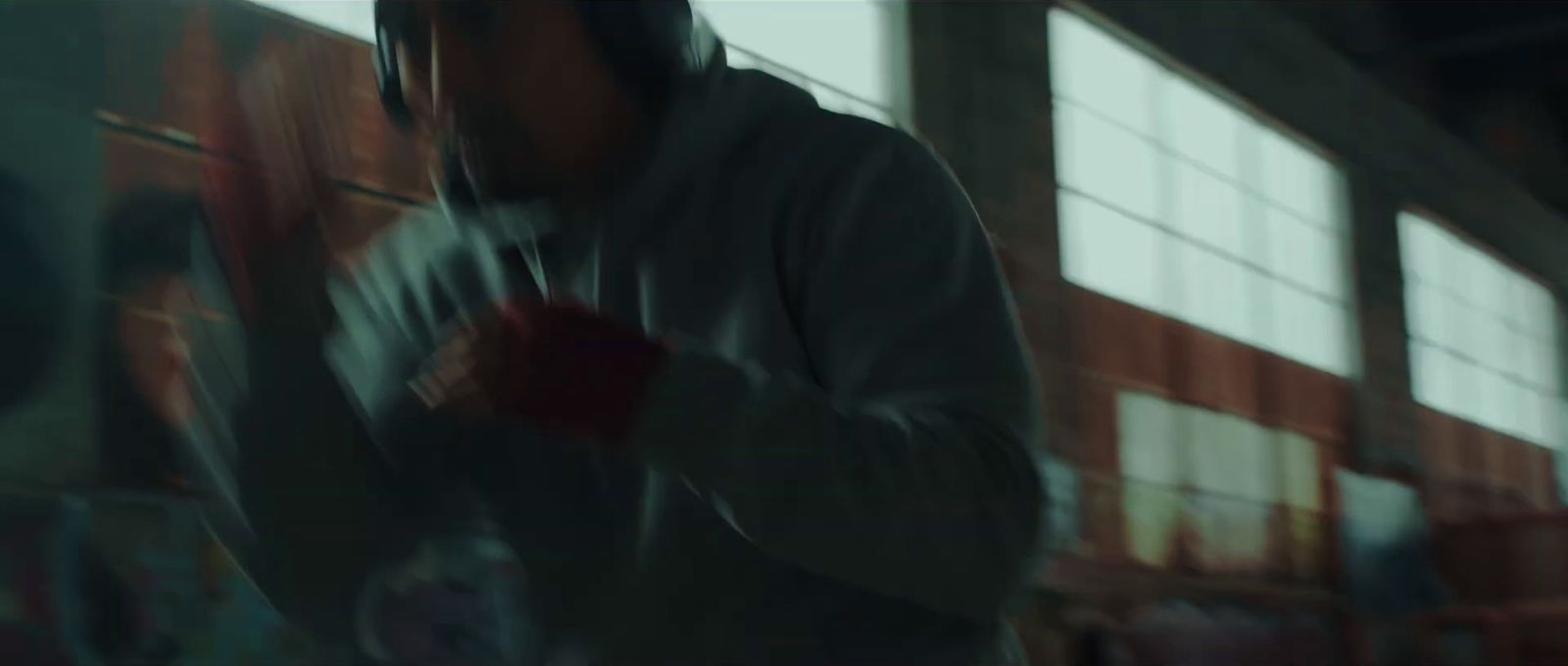 a blurry image of a man wearing a hoodie