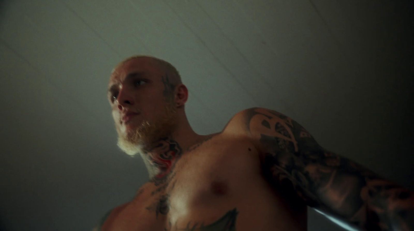 a man with tattoos on his arms and chest