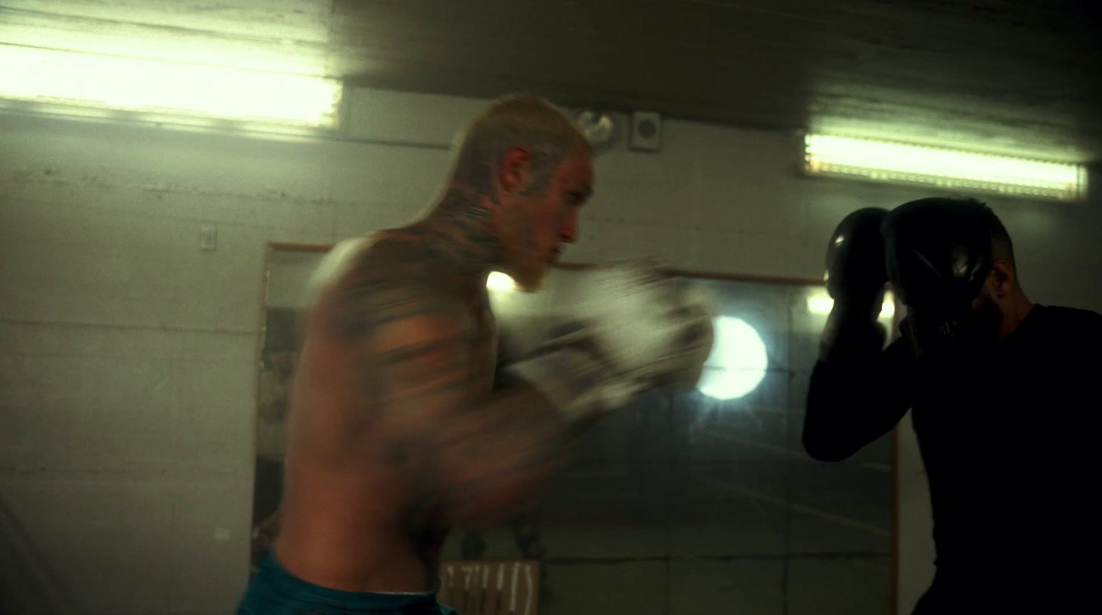 a man standing next to a man with a boxing glove