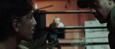 a man talking to another man in a boxing ring