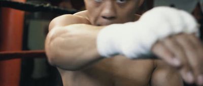 a man in a boxing ring holding a white glove