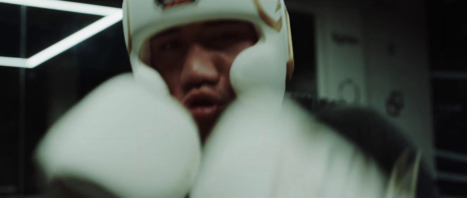 a close up of a person wearing boxing gloves