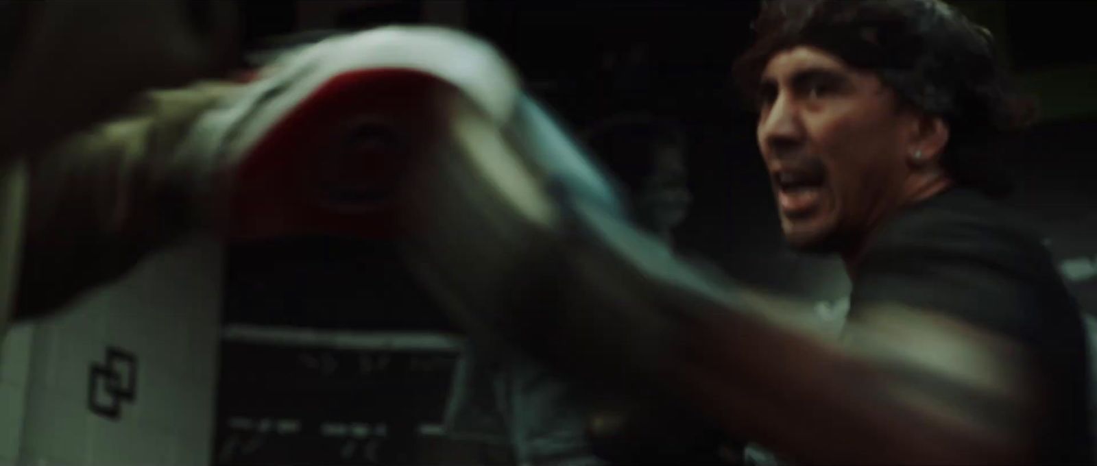 a man in a black shirt and a red and white boxing glove