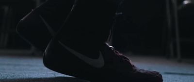 a close up of a person's shoes in the dark