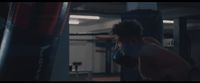 a man standing next to a punching bag in a gym