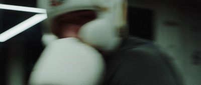 a blurry photo of a person wearing a white mask