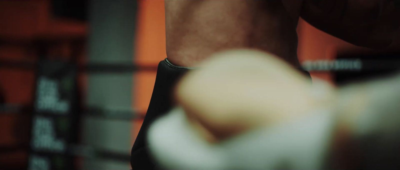 a blurry photo of a person's arm in a boxing ring