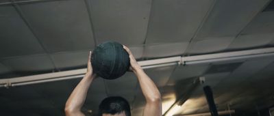 a man holding a green ball in his hands