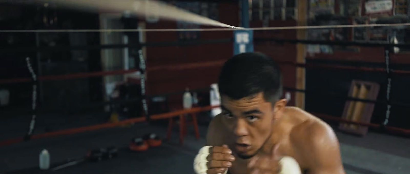 a man in a boxing ring with a punching glove