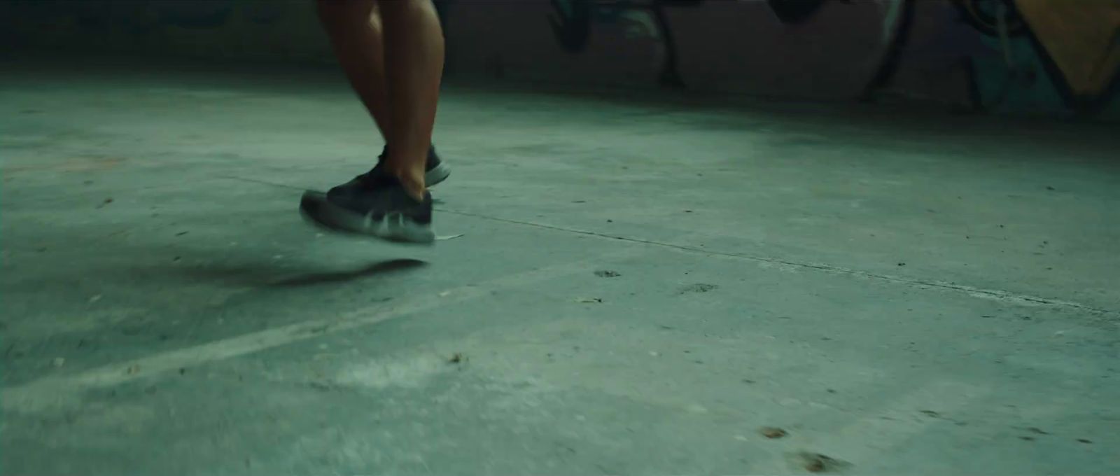 a person riding a skateboard on a concrete floor