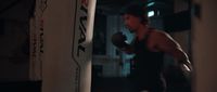 a man is boxing in a dimly lit room