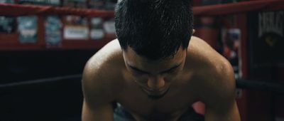 a shirtless man in a boxing ring