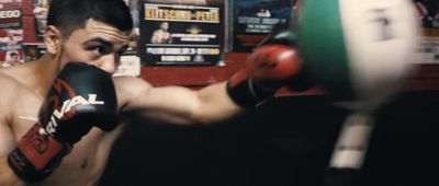 a man in a boxing ring with a punching glove