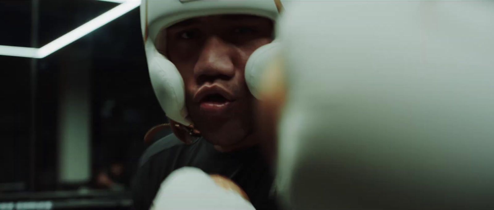 a man wearing a white helmet and boxing gloves