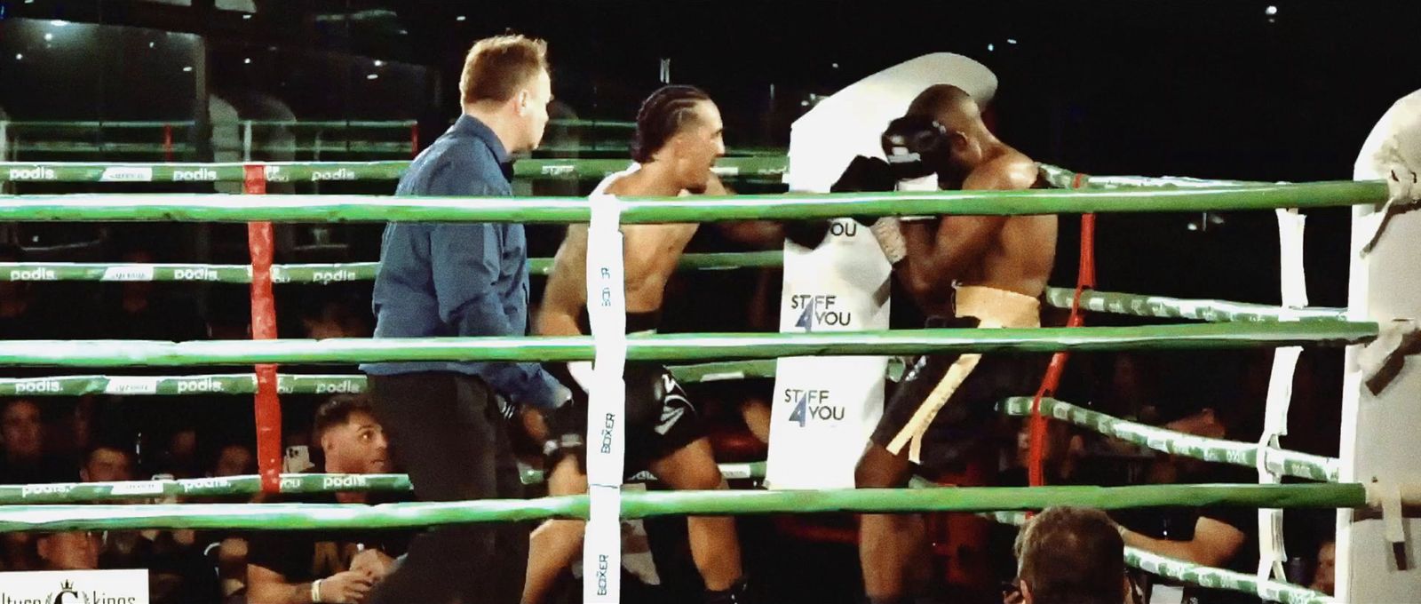 a group of men standing next to each other in a boxing ring