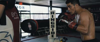 a man standing next to a punching bag