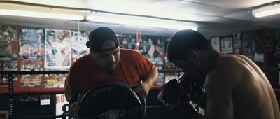 a couple of men standing next to each other in a boxing ring