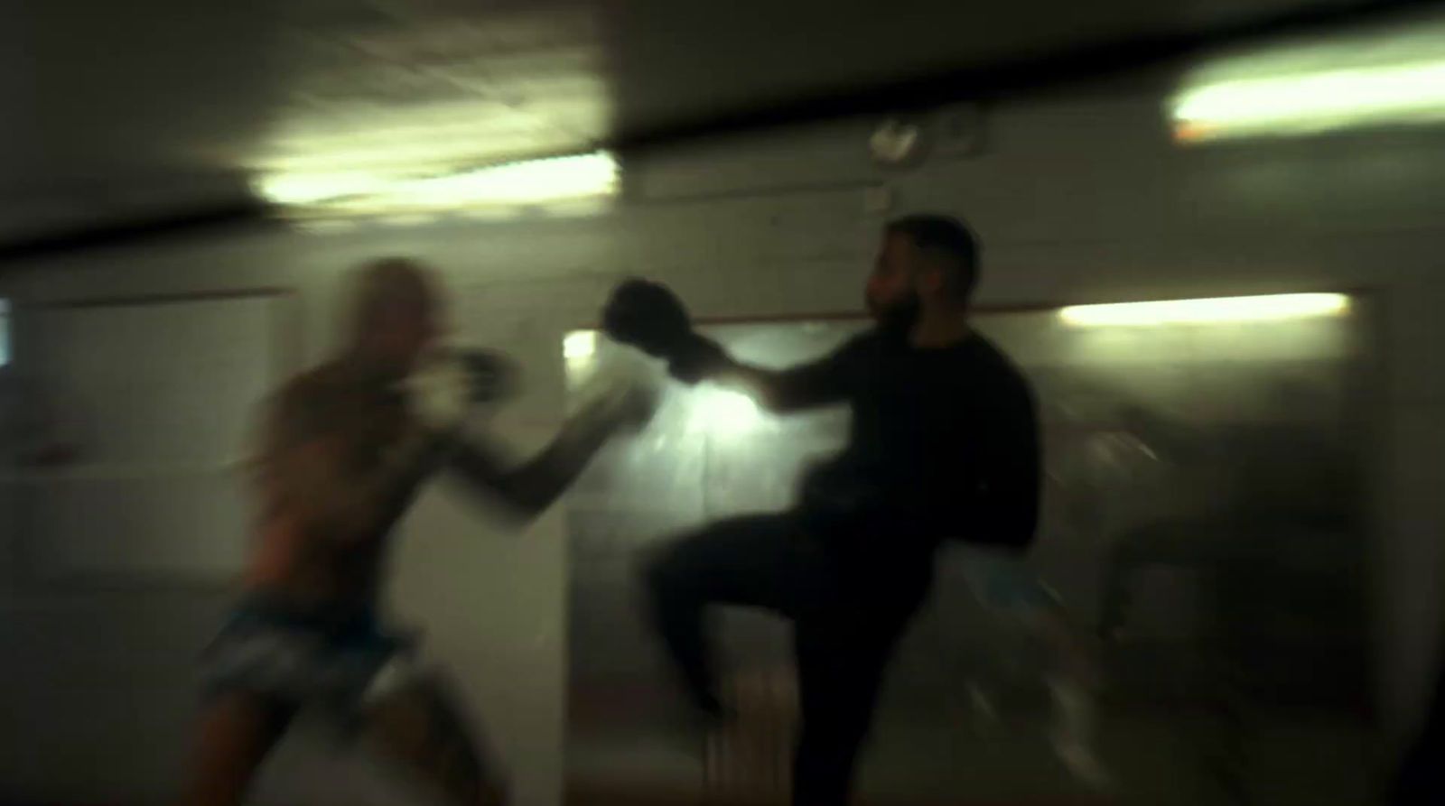 a blurry photo of a man and a woman boxing