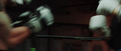 a close up of a person holding a pair of boxing gloves